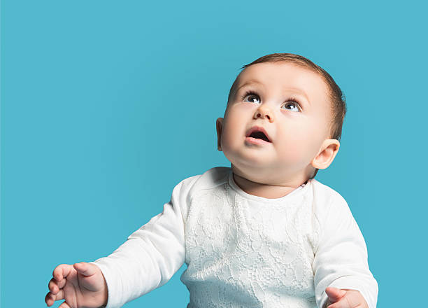 istock Little girl looking up 520177818