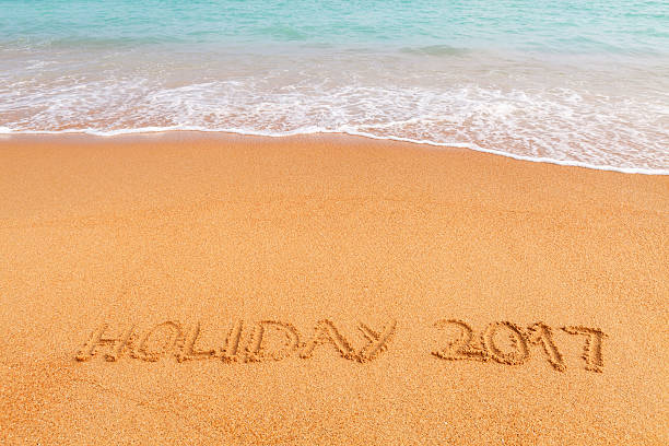 istock Inscription HOLIDAY 2017 on beautiful beach by the blue sea 520178228