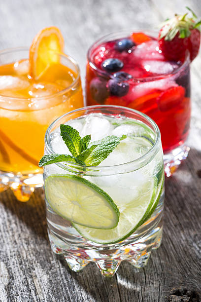 istock assortment of iced fruit drinks on wooden background, vertical 520179780