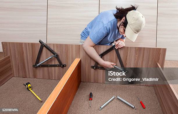 Flat Pack Furniture Assembly And Installation Service Women Handyman Working Stock Photo - Download Image Now