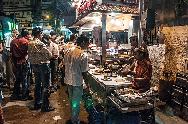 Mumbai, India- March 19, 2009: Men queuing at street food eatery