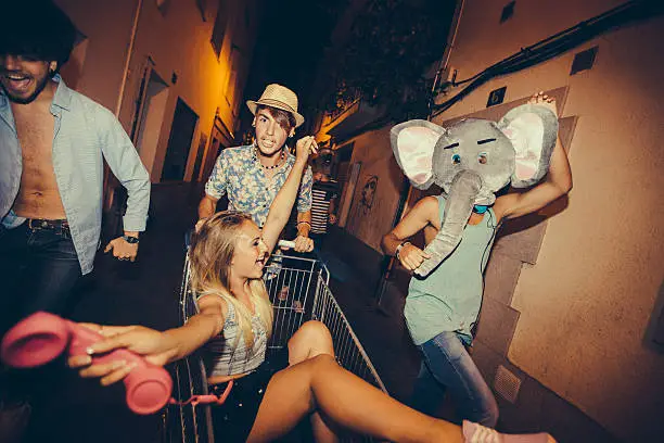 Photo of Partying Teenagers Being Silly In Street