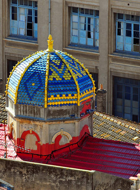 Béjaïa, Algeria: dome of the synagogue Béjaïa / Bougie, Kabylia, Algeria: dome of the synagogue with colorful tiles, red roofs and Ibn Sina highschool facade as background  kabylie stock pictures, royalty-free photos & images