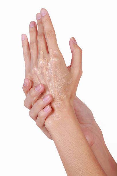 istock Woman applying cream to her hands. 520190899