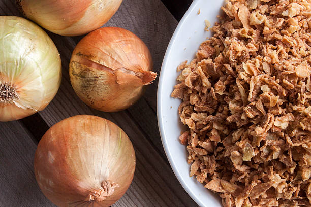 istock Few onions and a bowl  with dry onion flakes 520192047