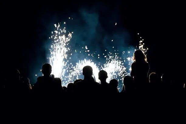 Photo of people in front of a fireworks