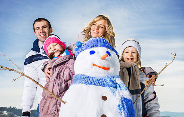 istock Family with snowman. 520193249