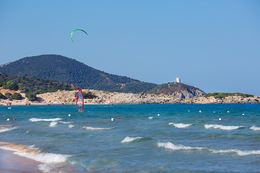 Panorama of beautiful beach with kitesurfer in Sardinia, Italy