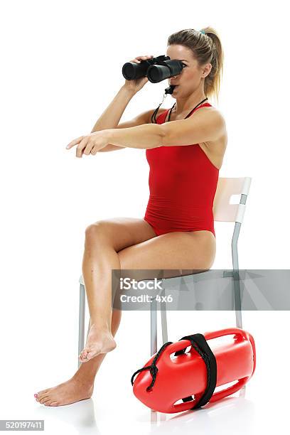 Female Lifeguard Searing With Binoculars Whistling Stock Photo - Download Image Now - Lifeguard, Binoculars, White Background