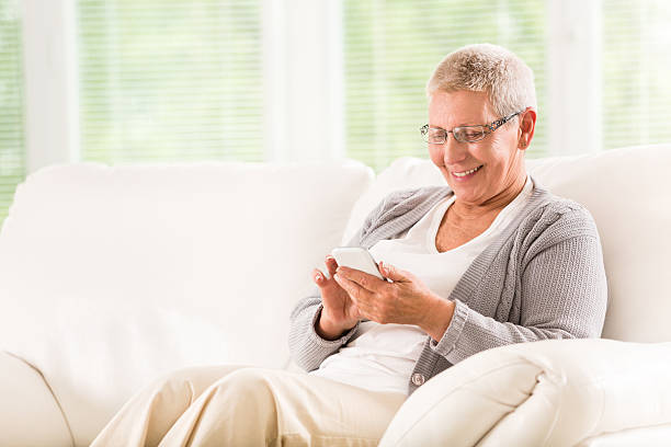 istock Senior woman text messaging on smart phone 520215091