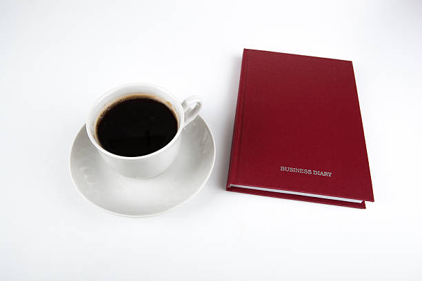 istock business diary with cup of coffee 520218281