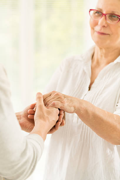 istock Young man cares for senior woman 520218671