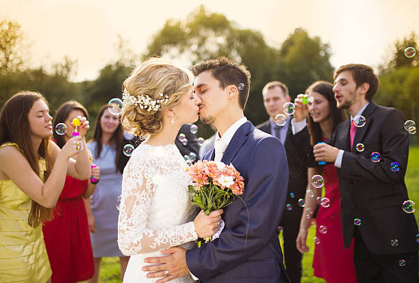 istock Newlyweds kissing at wedding reception 520219143