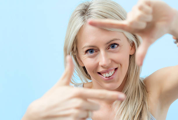 istock Young woman making photo frame around her face 520219491