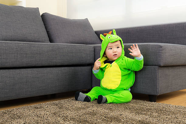 istock Baby with dinosaur halloween party costume 520220249
