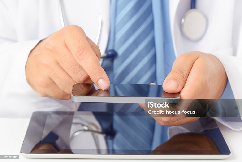 Doctor using tablet pc and smart phone Doctor using tablet pc and smart phone. Accidents and Disasters Stock Photo