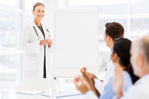 istock Doctor Looking At Medical Team Clapping For Her 520220451
