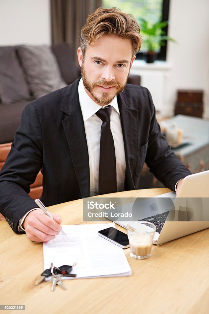 Young handsome, bearded businessman working from home Accountancy Stock Photo