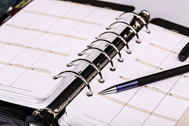 istock Personal organizer or planner with pen on white background 520221645