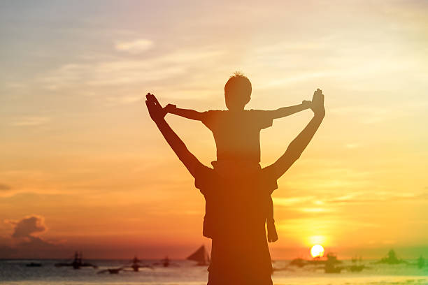 istock happy father and son on sunset beach 520221943