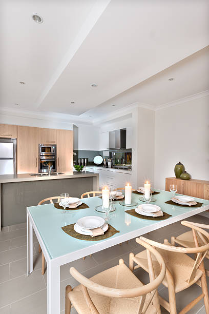 istock Modern dining room with candles and modern kitchen 520222704
