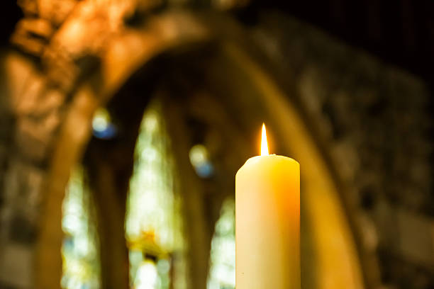 Church candle Church candle with stained glass window in the background allegory painting stock pictures, royalty-free photos & images