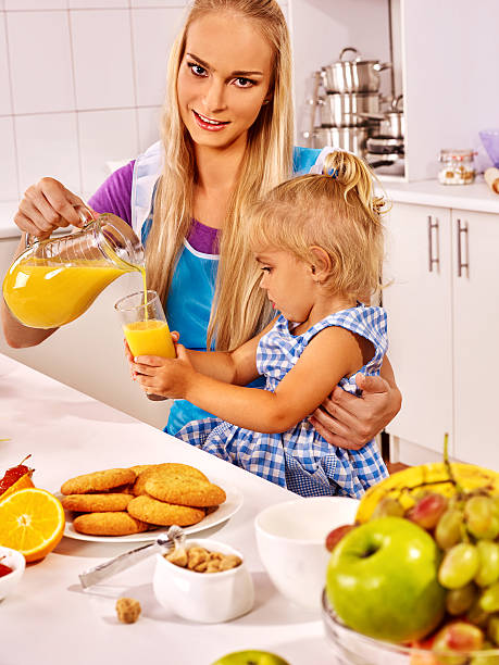 istock Mom and daughter having breakfast in the kitchen 520223322