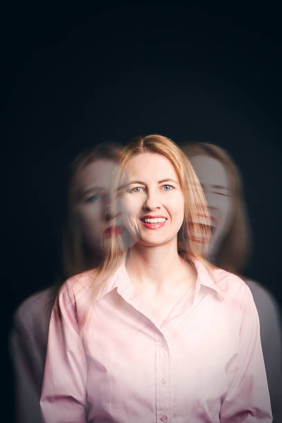 Woman Struggling With Emotions Concept A concept image of a woman appearing to be happy on the outside but her anger and sadness shows through. Long Time Exposure stock pictures, royalty-free photos & images