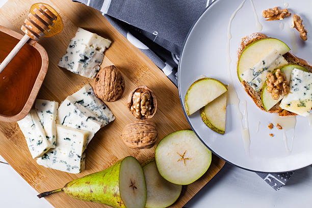 istock Sandwich with blue cheese, slices of pear, nuts and honey. 520224174