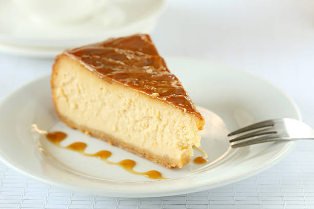 istock Fresh and tasty caramel cheesecake on white plate 520225378