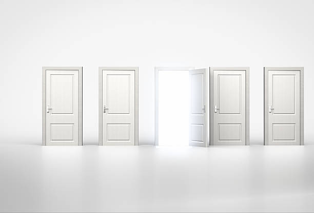 istock Concept of opportunity. Light shining through one door 520225600