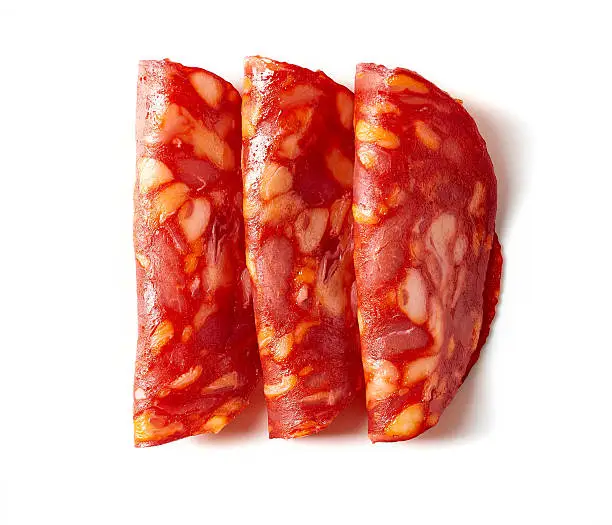 Sliced chorizo sausage isolated on white background, top view