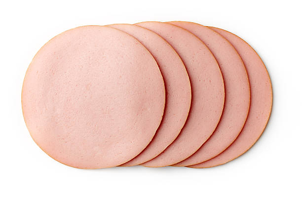 Boiled ham sausage isolated on white background Sliced boiled ham sausage isolated on white background, top view baloney photos stock pictures, royalty-free photos & images