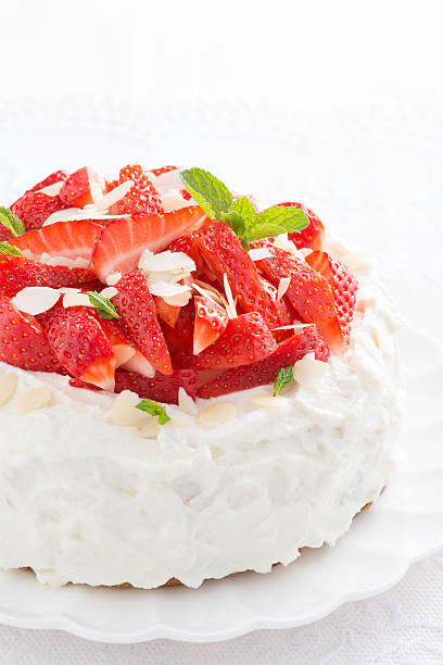 istock cake with whipped cream and strawberries, vertical 520226730