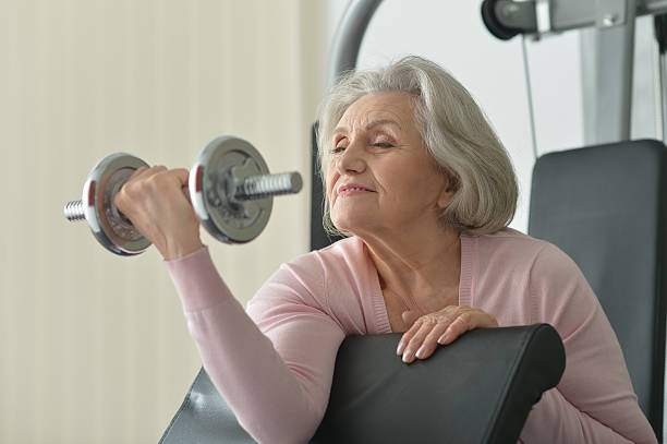 istock Elderly woman exercising in gym 520226874
