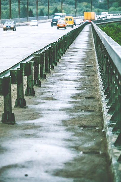 istock wet pedestrian zone on the car bridge 520228746
