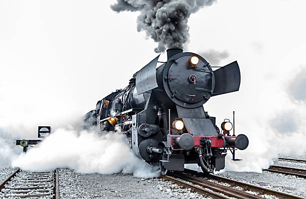 Old steam locomotive, smoke Old steam train leaving the railway station in Nova Gorica, Slovenia, Europe. Lots of black and gray steam hiding the locomotive, full frame, XXXL steam train stock pictures, royalty-free photos & images