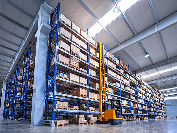 istock Forklift Lifting a cardboard box in warehouse aisle 520229636