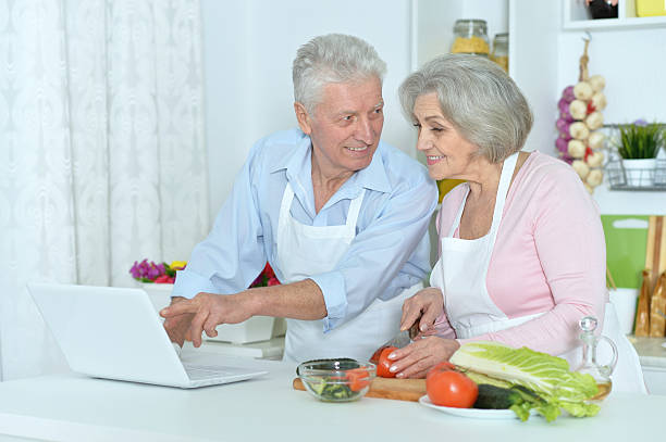 istock senior man and woman  in the kitchen 520229746