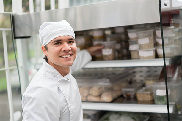 Chef working at a takeaway restaurant Chef working at a takeaway restaurant organizing food and looking at the camera smiling restaurant kitchen workers stock pictures, royalty-free photos & images