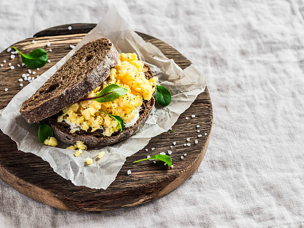 istock Scramble egg sandwich on rustic wooden background 520232552