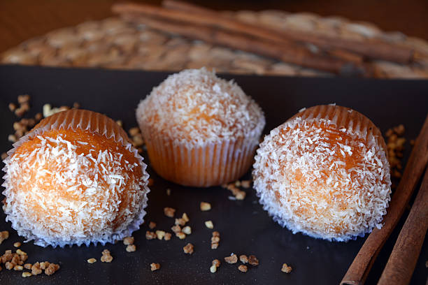 istock Three homemade muffins with grated coconut. 520233526