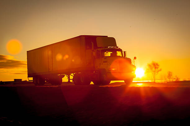 istock Tractor trailer driving down the highway at sunrise. 520234160