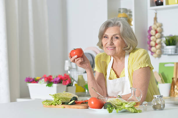 istock Senior woman cooking in kitchen 520236420