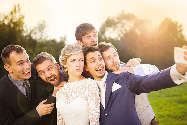 istock Bride with groom and his friends taking selfie 520238245
