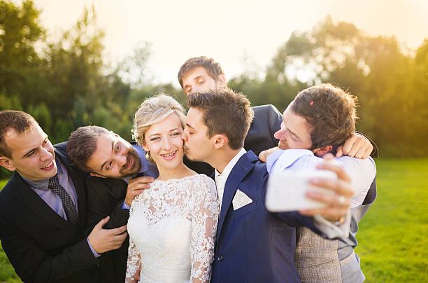 istock Bride with groom and his friends taking selfie 520238247