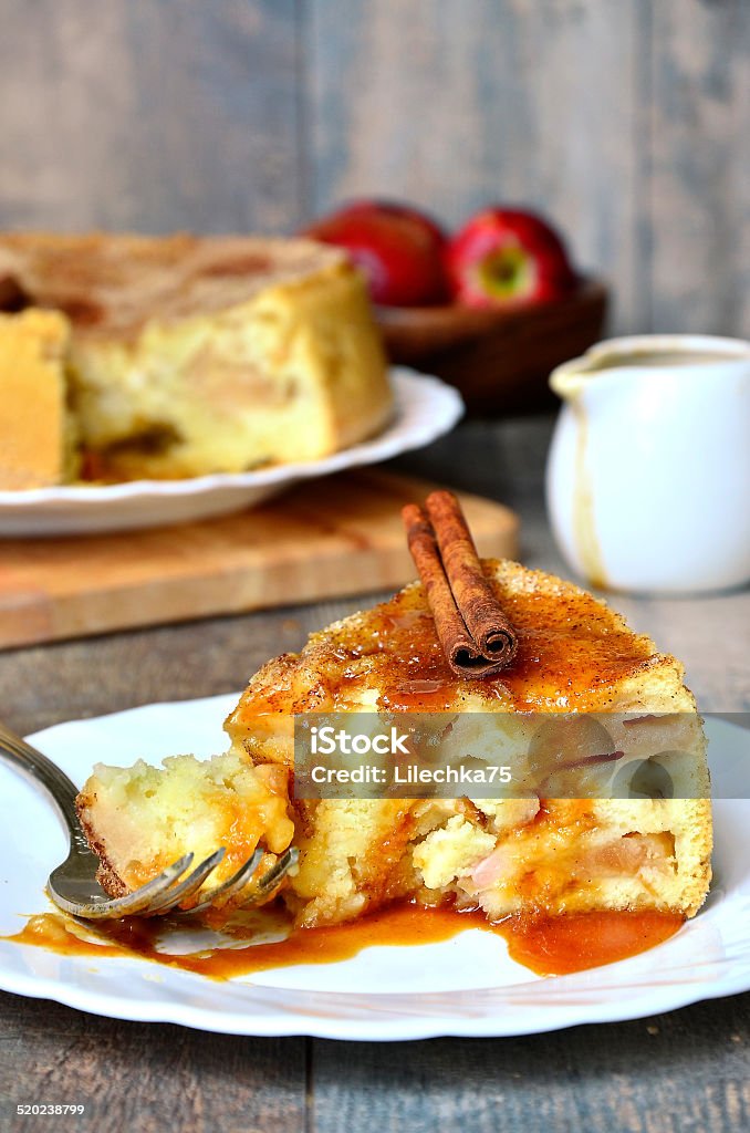 Apple pie with cinnamon and caramel sauce. Apple pie with cinnamon and caramel sauce on a rustic background. Backgrounds Stock Photo