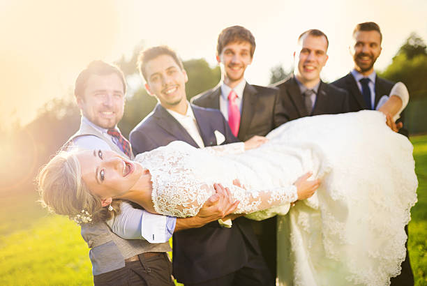 Groom with his friends holding bride
