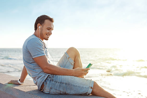 istock mobile smartphone in man's hands near the sea 520239927