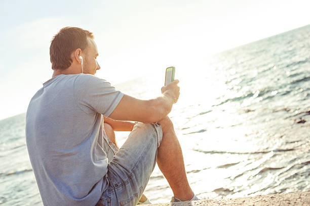istock mobile smartphone in man's hands near the sea 520240559